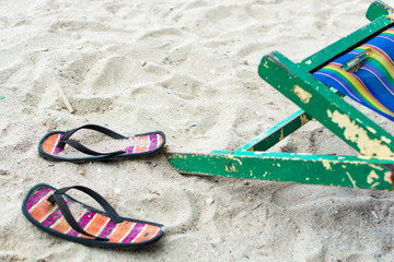 Gone swimming - empty beach chair and flip-flops