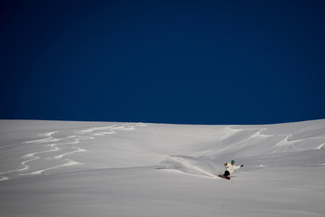 Man snowboarding on snow in the mountains