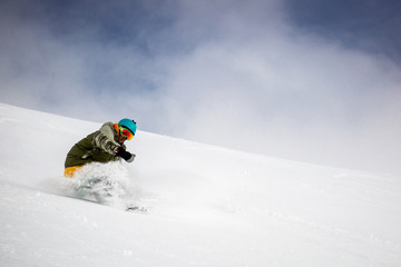 Man snowboarding on snow in the mountains