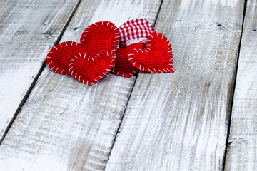 Collection of red and white hearts on rustic wood background