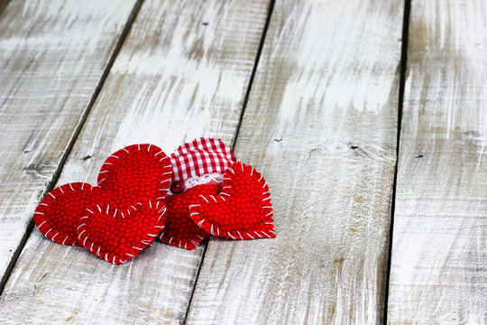 Collection of red and white hearts on rustic wood background