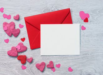 Valentines Letter with heap of small hearts on wooden background. Copy space for your text