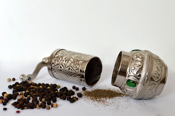 Pepper mill, peppercorn and grounded pepper