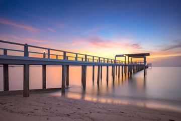 Fototapeta na wymiar Sunset sky with the pier bridge to the sea