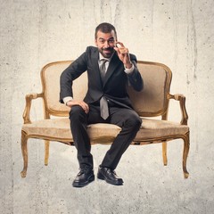 Businessman doing tiny sign