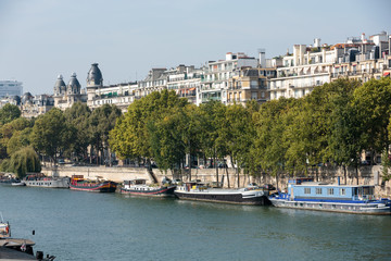 Fototapeta na wymiar Famous quay of Seine in Paris with barges in Summer day. Paris, France