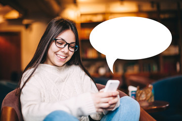 Smiling gir with smartphone and text bubble