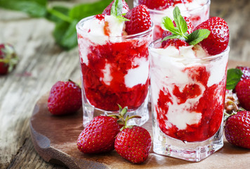 Vanilla ice cream with wild strawberry and mint, selective focus