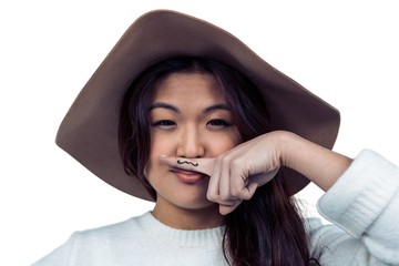 Asian woman with mustache on finger posing for the camera