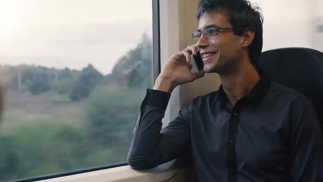 Man Answering the Phone in Moving Train. Shot on RED Cinema Camera.
