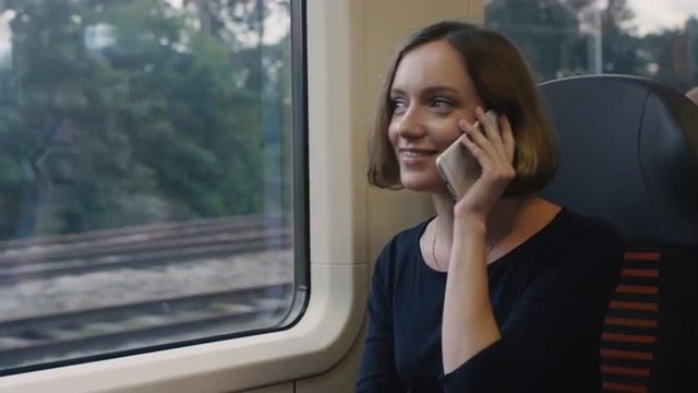 Woman Answering the Phone in Moving Train. Shot on RED Cinema Camera.