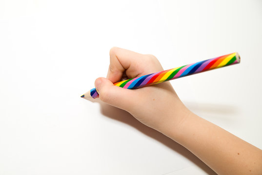 Kid's rigth hand holding a pencil on over white