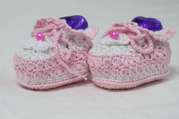 Fototapeta na wymiar crochet baby booties on white background