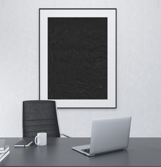 Working place with blank frame on the wall