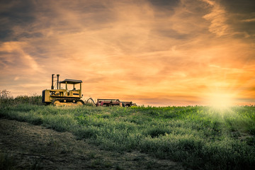 Fototapeta premium Tractor and amazing sunset