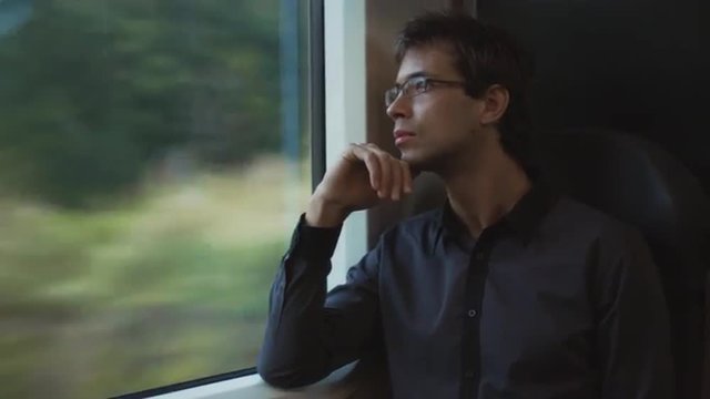 Man Looking through Window in Moving Train. Shot on RED Cinema Camera.