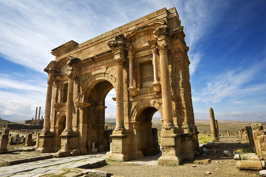 Algeria. Timgad (ancient Thamugadi or Thamugas). Triumphal arch, called Trajan's Arch and fragment of Decumanus Maximus street