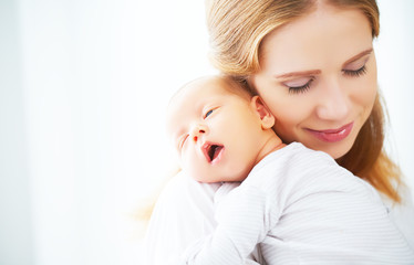 newborn baby in tender embrace of mother