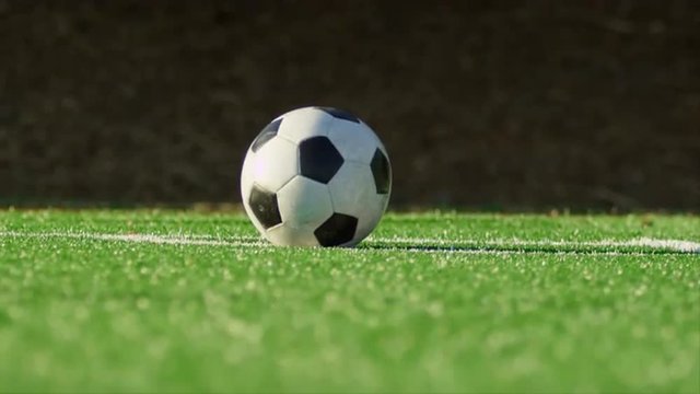 Close up of a soccer ball being kicked back into play