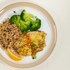 Tilapia Fish with Broccoli and Brown Rice. Selective focus.