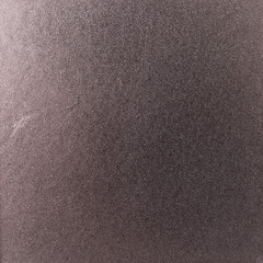 Fototapeta na wymiar Background texture of a shiny metal sheet with a rough stippled