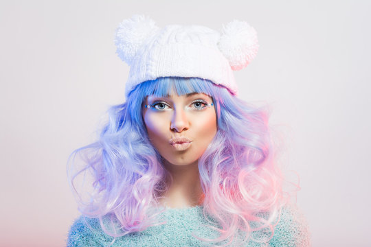 Cute young fashion woman with pastel purple and pink hair and makeup