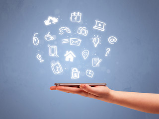 Hand holding tablet phone with drawn icons