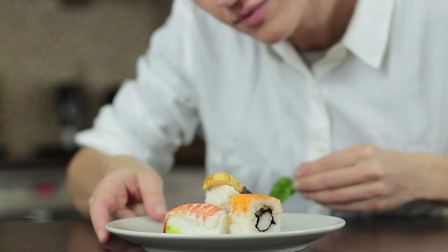 Sushi master preparing sushi in Japanese restaurant, close up
