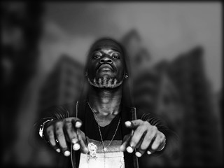 Double exposure of transgressive man and city blurred background