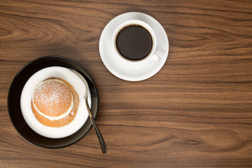 Swedish Semla in hot milk, served with a cup of coffee.