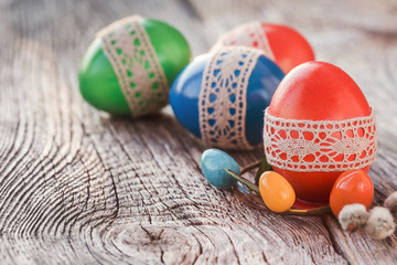 Easter eggs decorated with lace on wooden table. Selective focus, toned, soft focus 