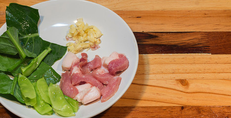 Raw fried rice, pork, garlic, kale, resting on the plate.