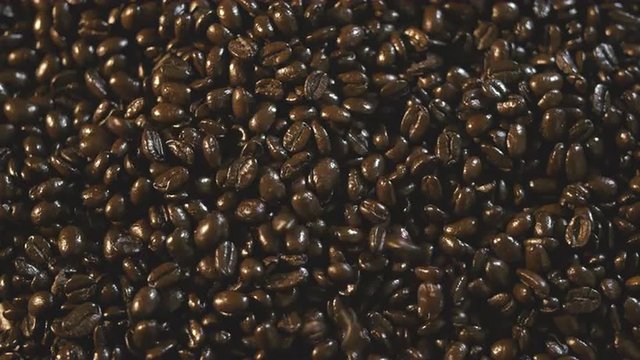 Organic Coffee Beans Falling and Landing on Pile