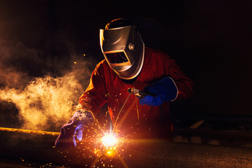 Industrial Worker at the factory welding closeup - obrazy, fototapety, plakaty
