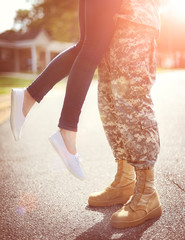 Young military couple kissing each other, homecoming concept, wa