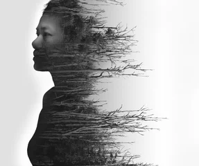 Double exposure portrait of young woman and dried forest © naruedom