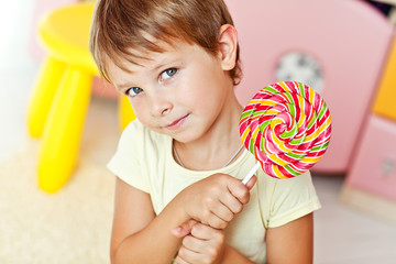 Happy kid with a big candy 