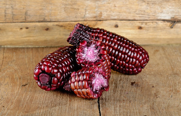 Red corn on the wooden background