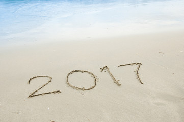2017 on sand beach with sea wave