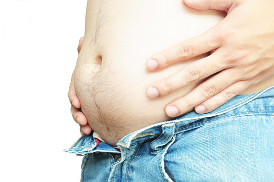 Fat man with a big belly cannot wearing jeans on white backgroun