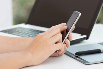 hand touch on black phone on desk