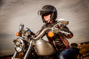 Fototapeta na wymiar Biker girl on a motorcycle