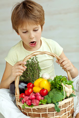 Happy little boy with fresh vegetables 