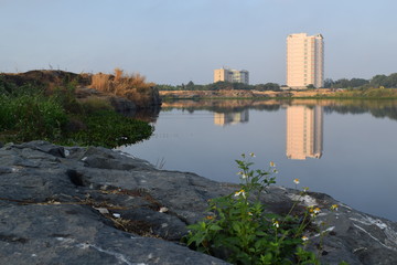Fototapeta premium river bank with the building reflect on the water surface