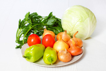 salad with vegetables on white background. Mixed vegetables on a plate