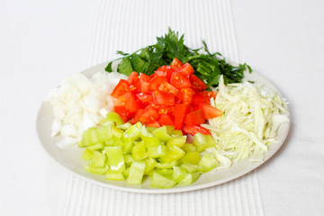 salad with vegetables on white background. Mixed vegetables on a plate