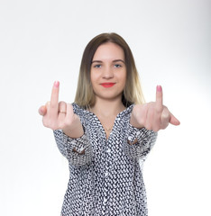 Sporty girl in jeans shorts with fit ass show middle finger, fuck you off sign between her legs. funny lifestyle portrait, concept  rebel