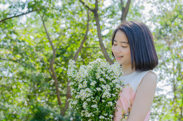Young Asian girl with flower outdoor