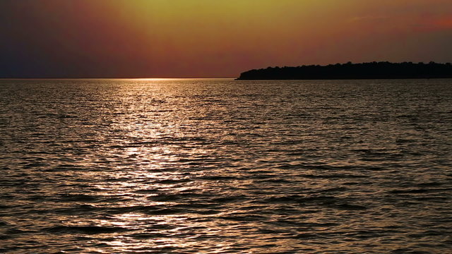 A colorful sunset sky is reflected upon the clam waters of Eagle Harbor at Ephraim in Wisconsin's scenic Door County. Looping.