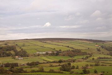 Fototapeta premium Patchwork Patterns. The land in England has been farmed for centuries and the definite boundaries of the fields have been established forever creating a patchwork pattern on the countryside.